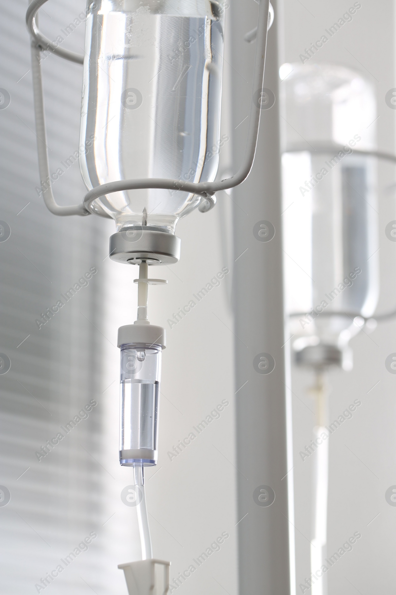 Photo of IV drip against blurred light background. Intravenous therapy