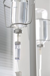 Photo of IV drip against blurred light background. Intravenous therapy