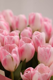 Photo of Beautiful bouquet of fresh pink tulips on blurred background, closeup