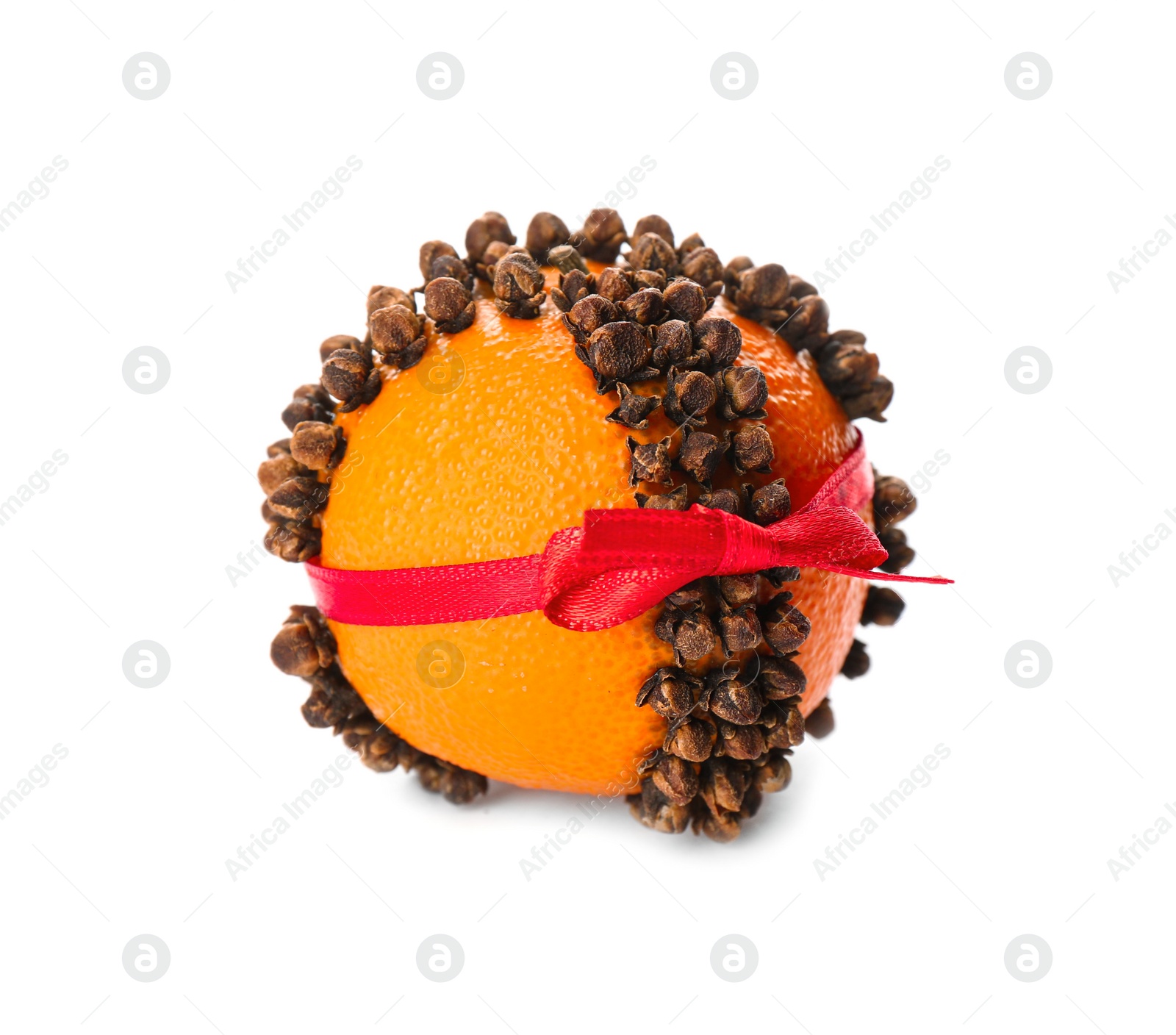 Photo of Pomander ball with red ribbon made of fresh tangerine and cloves isolated on white