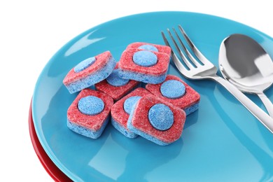 Dishware with many dishwasher detergent tablets on white background