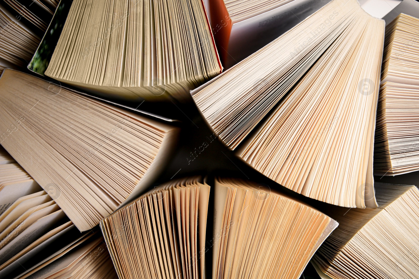 Photo of Collection of different books on white shelf, above view