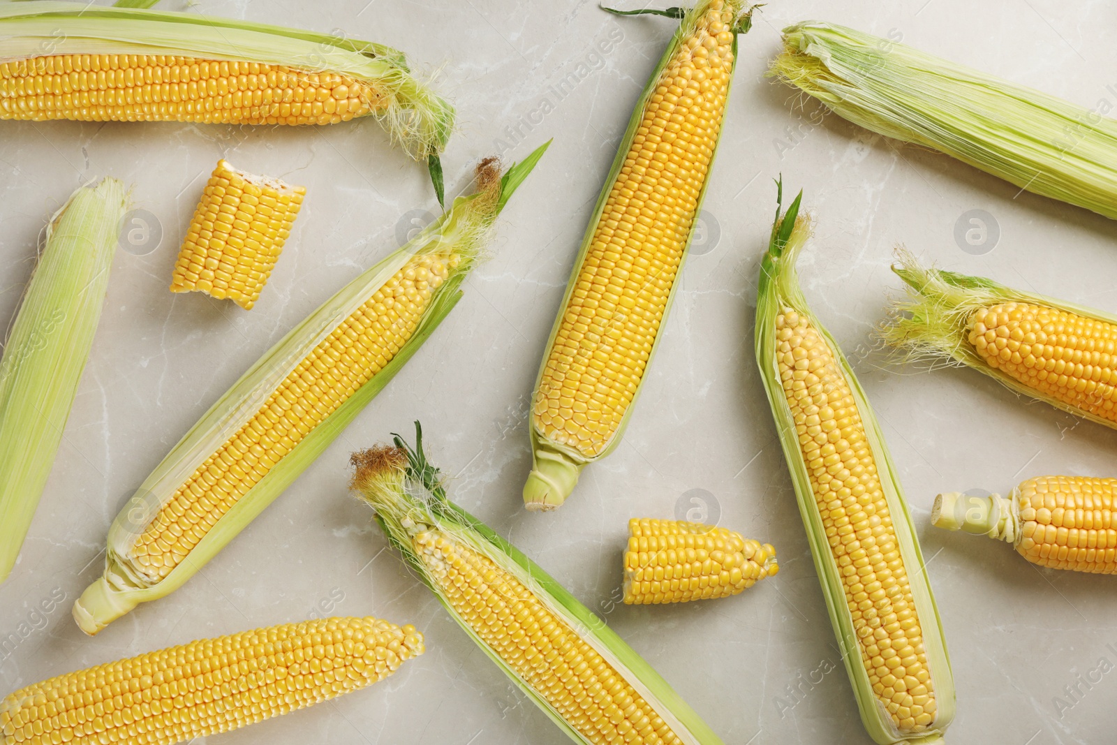 Photo of Tasty sweet corn cobs on table, top view