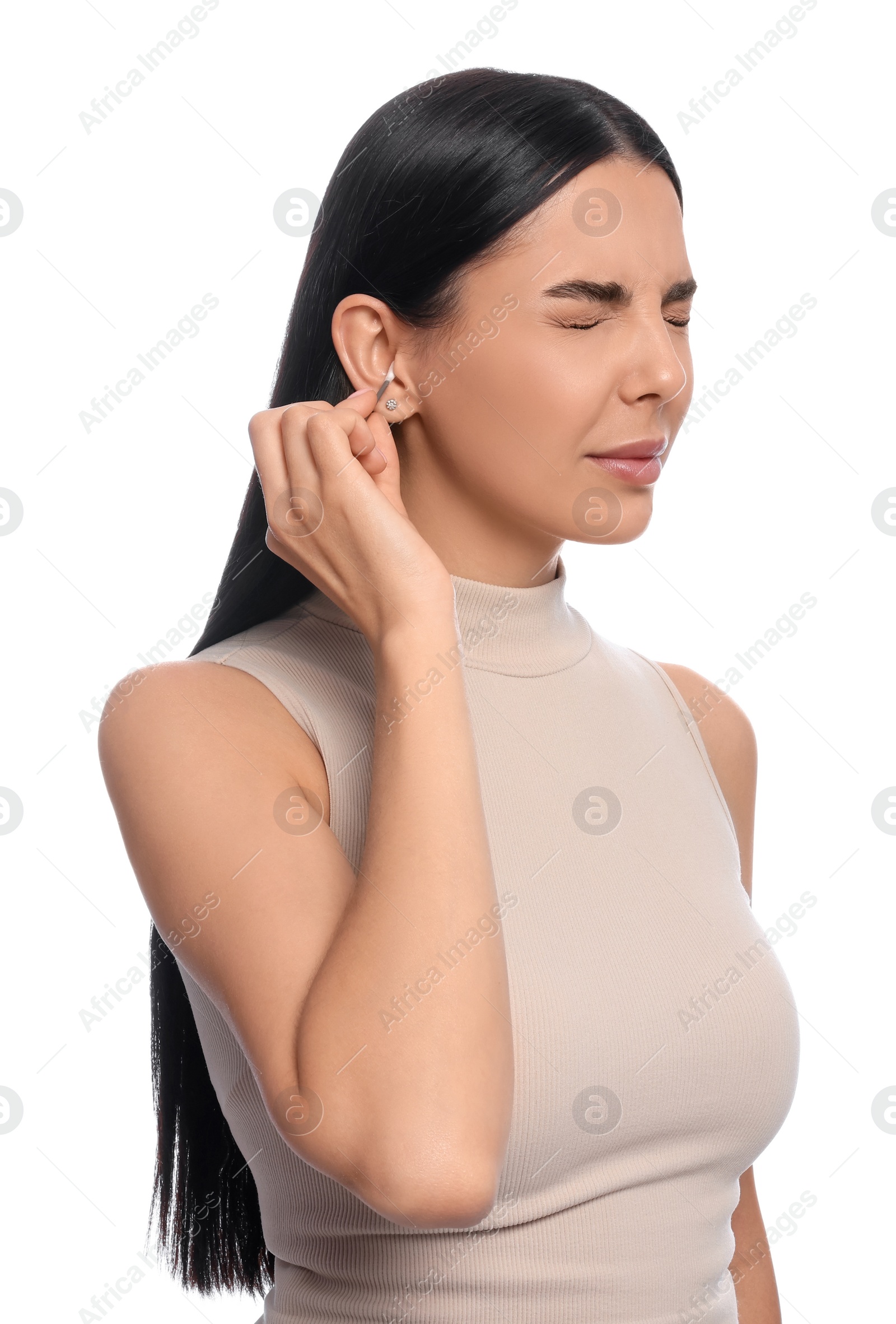 Photo of Young woman cleaning ear with cotton swab on white background