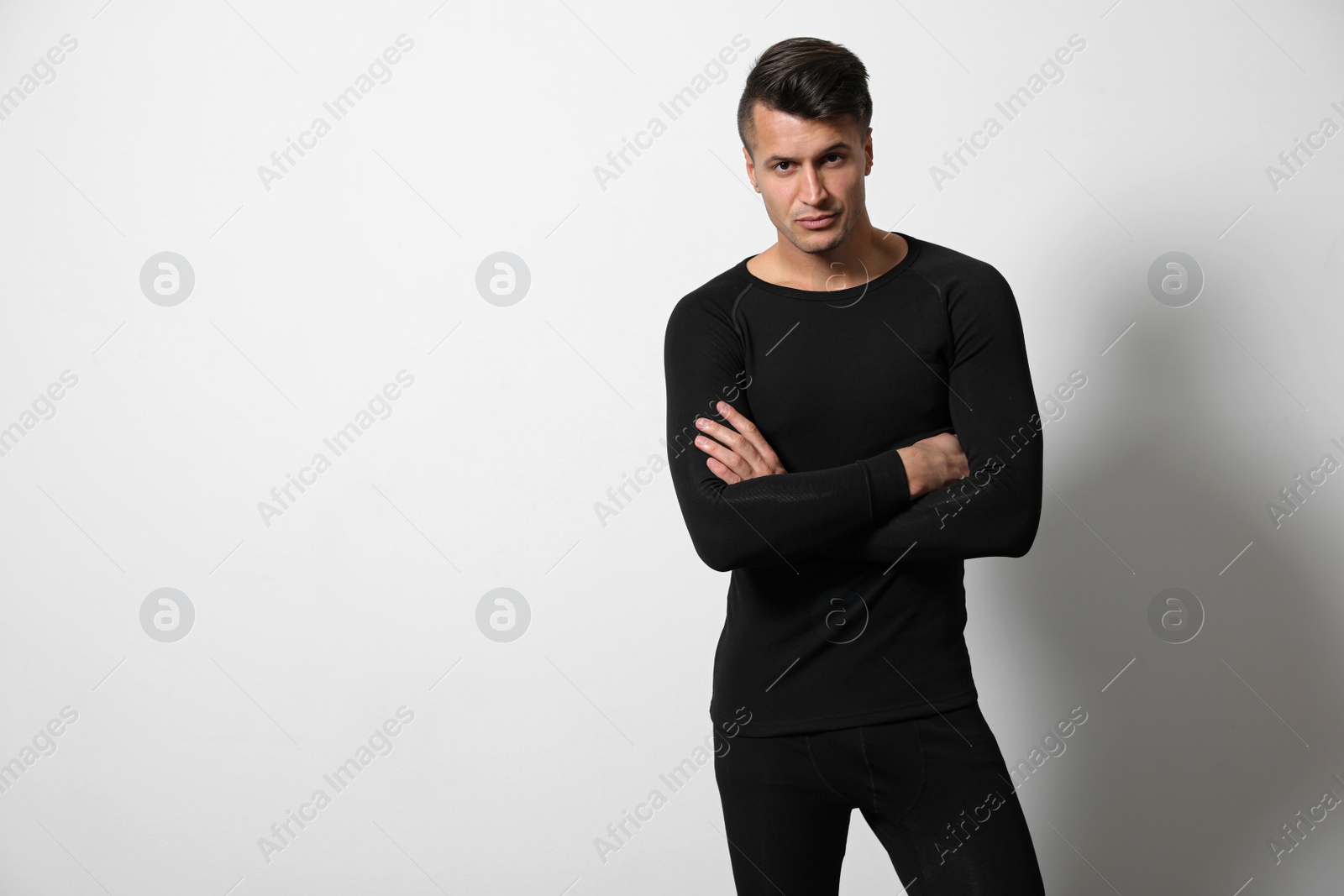 Photo of Man wearing thermal underwear on light grey background. Space for text