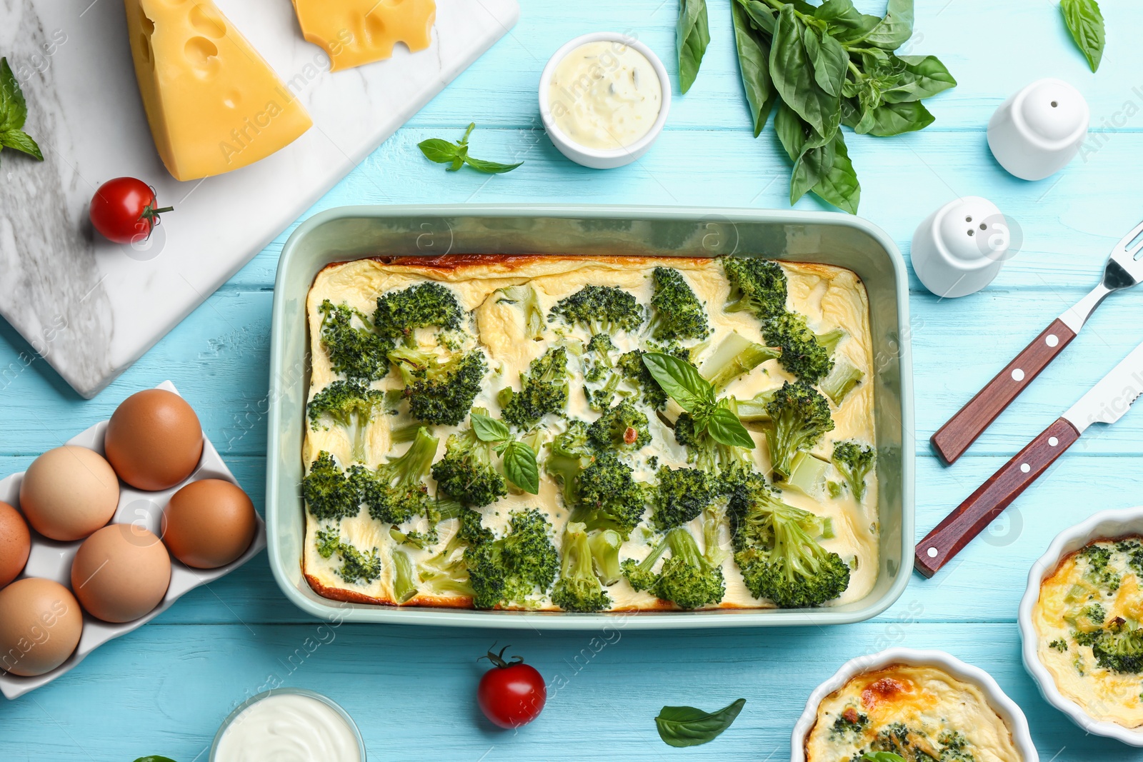 Photo of Flat lay composition with tasty broccoli casserole on blue wooden table