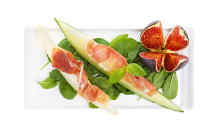 Photo of Plate with tasty melon, jamon, figs and spinach isolated on white, top view