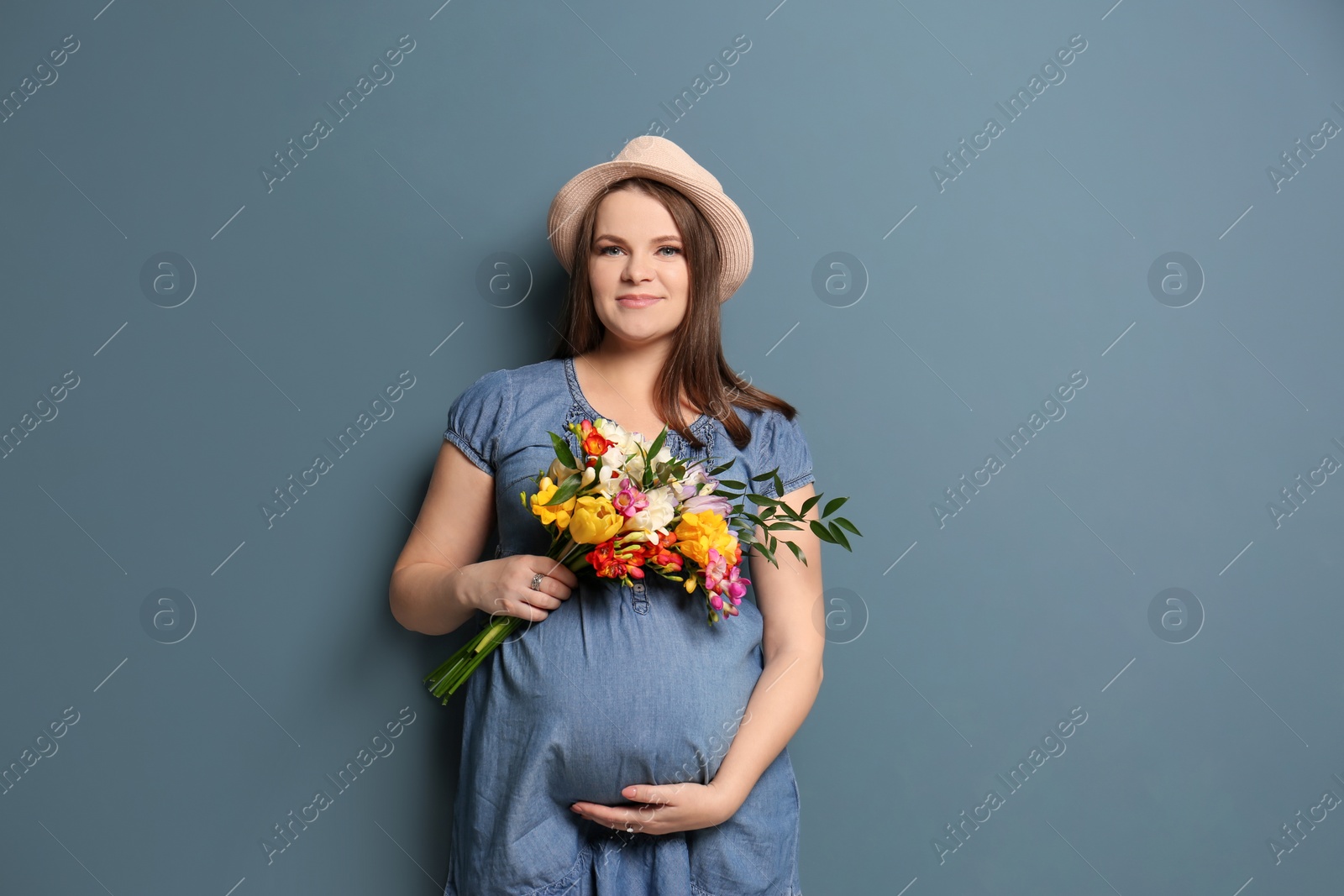 Photo of Beautiful pregnant woman on color background