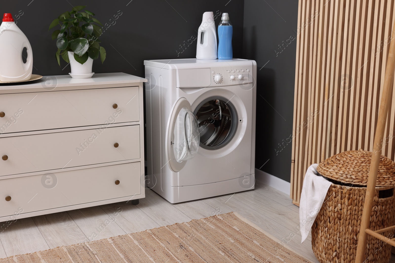 Photo of Laundry room interior with washing machine and furniture