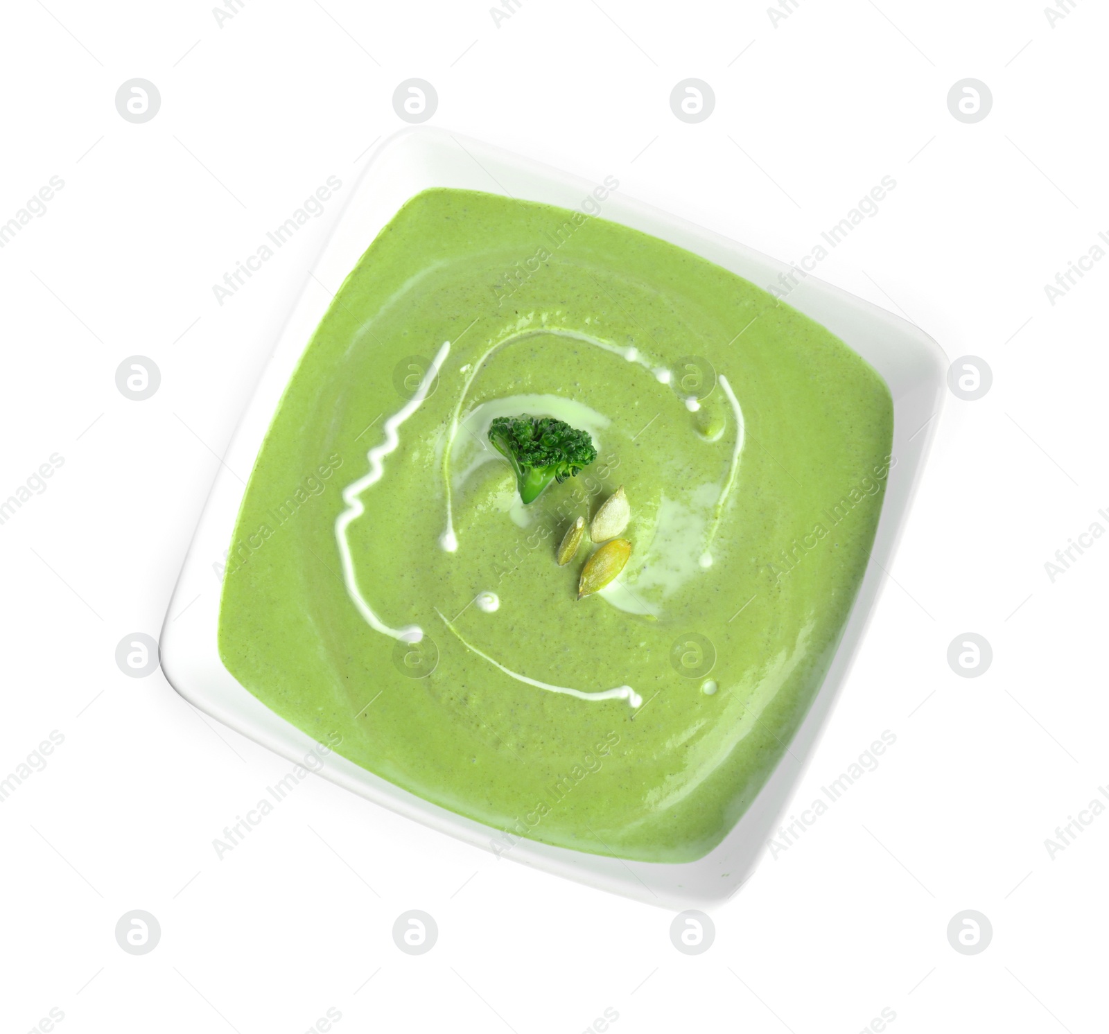 Photo of Delicious broccoli cream soup isolated on white, top view