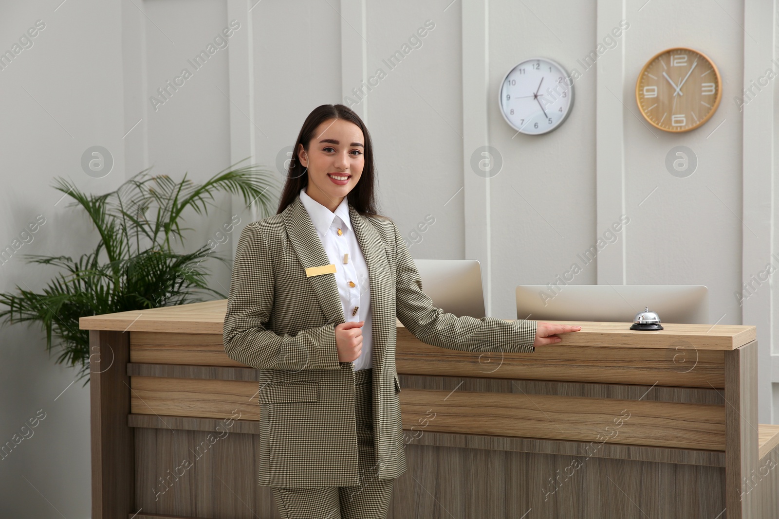 Photo of Portrait of beautiful receptionist near counter in hotel