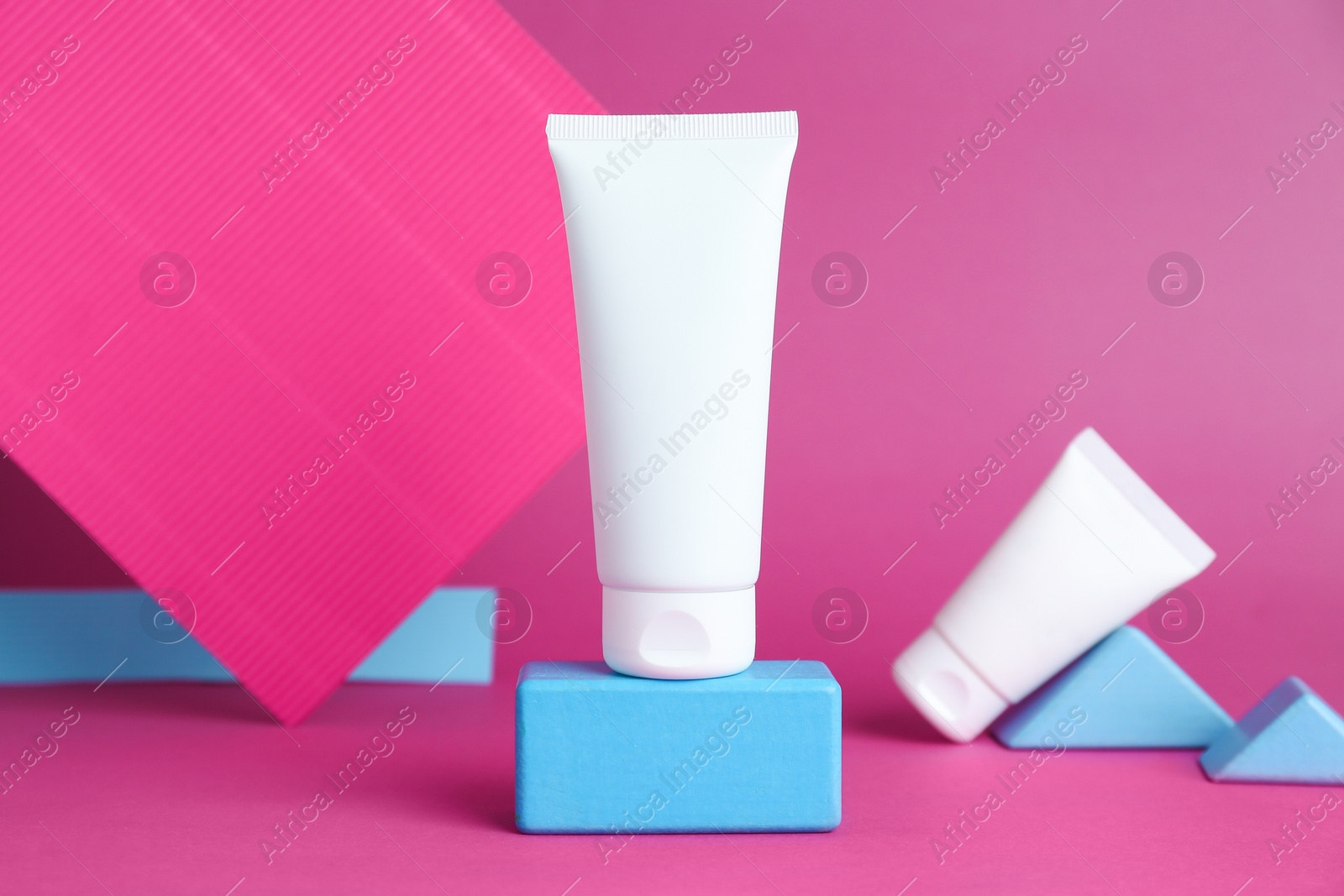 Photo of Composition with tubes of hand creams on pink background. Mockup for design