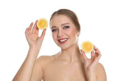 Photo of Young woman with cut lemon on white background. Vitamin rich food