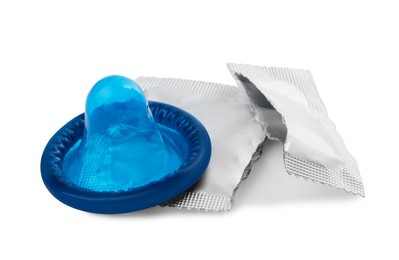 Photo of Unpacked condom and torn package on white background. Safe sex