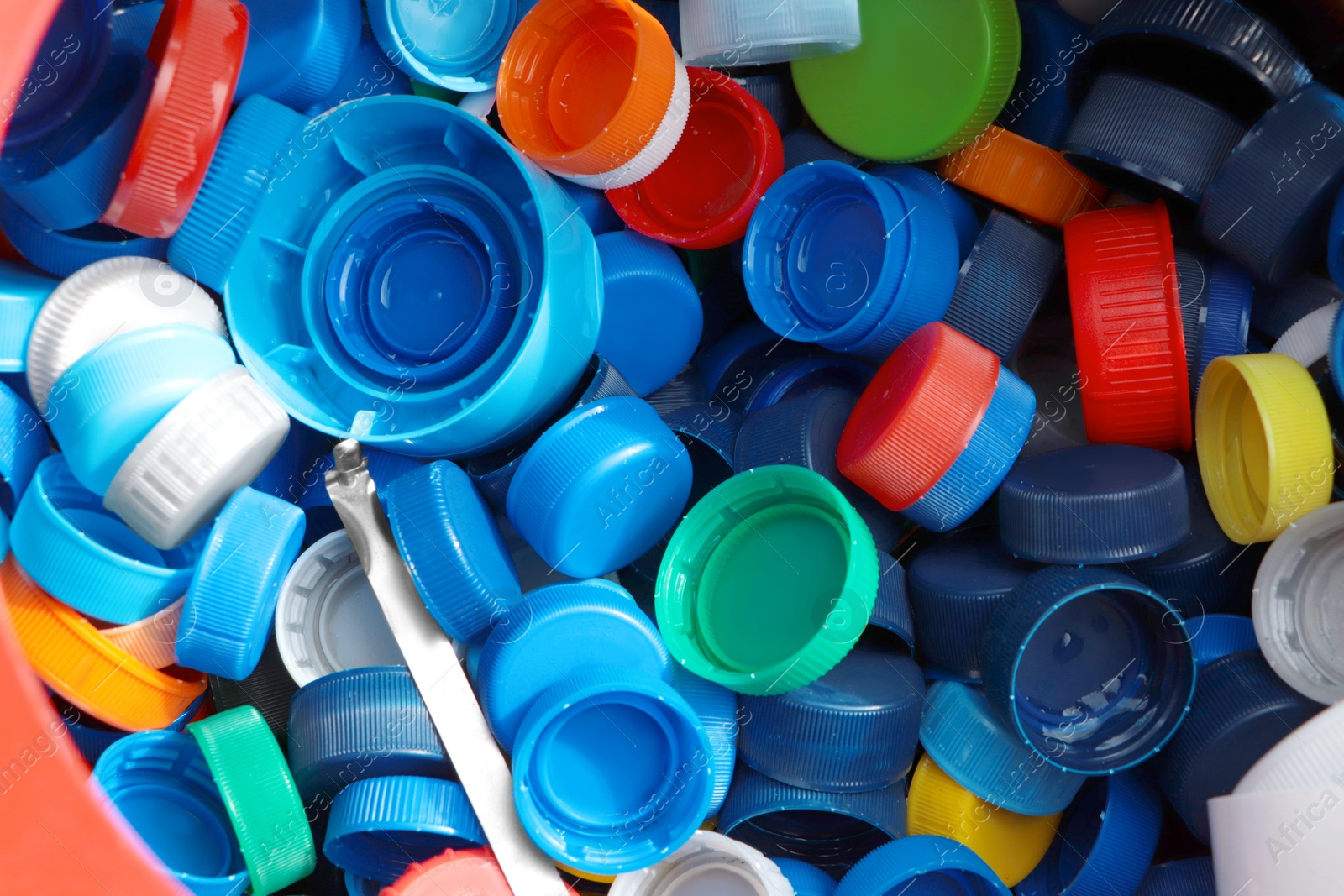 Photo of Different colorful bottle caps, top view. Plastic recycling