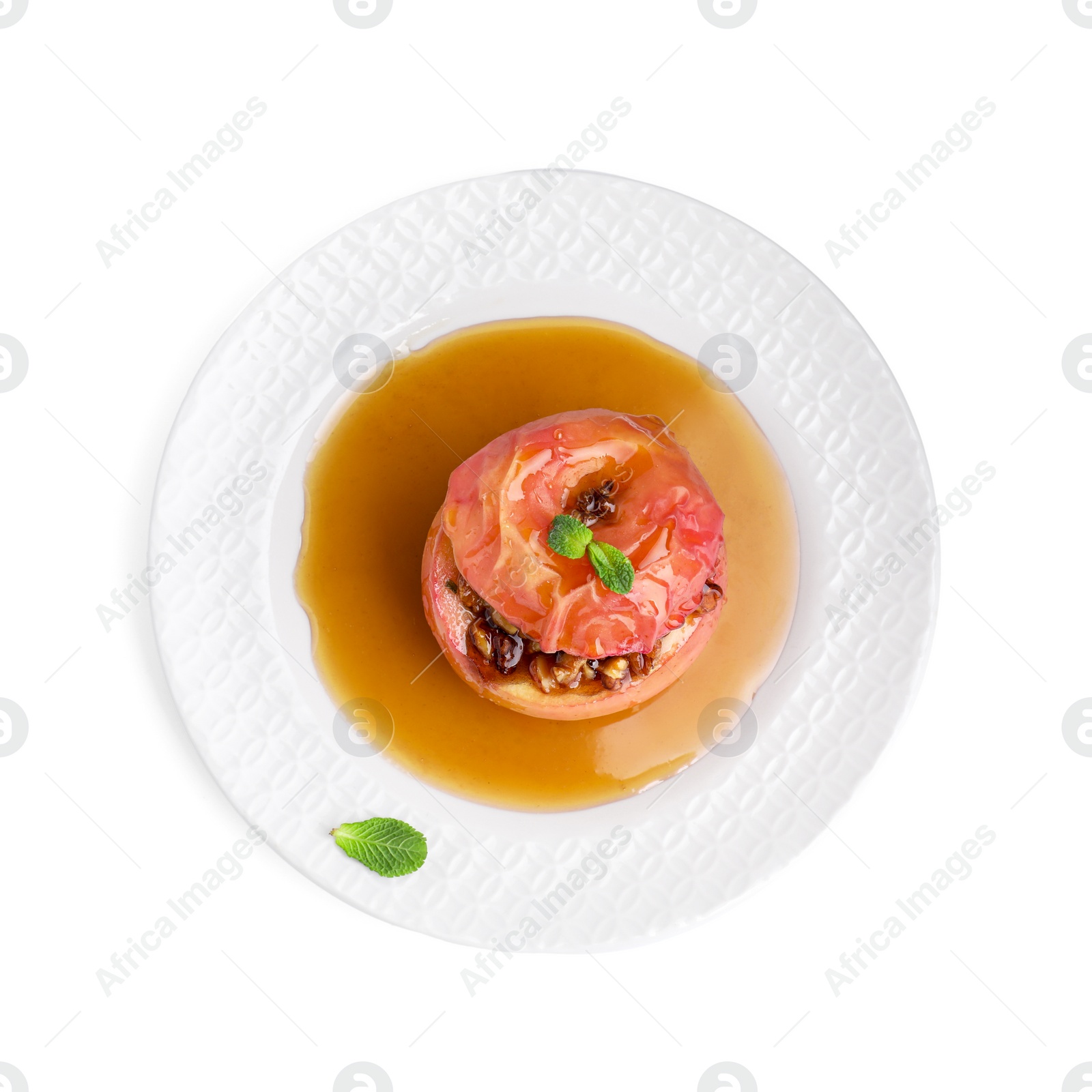 Photo of Tasty baked apple with nuts, honey and mint isolated on white, top view