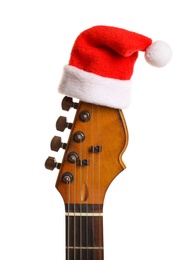 Photo of Guitar with Santa hat isolated on white. Christmas music concept