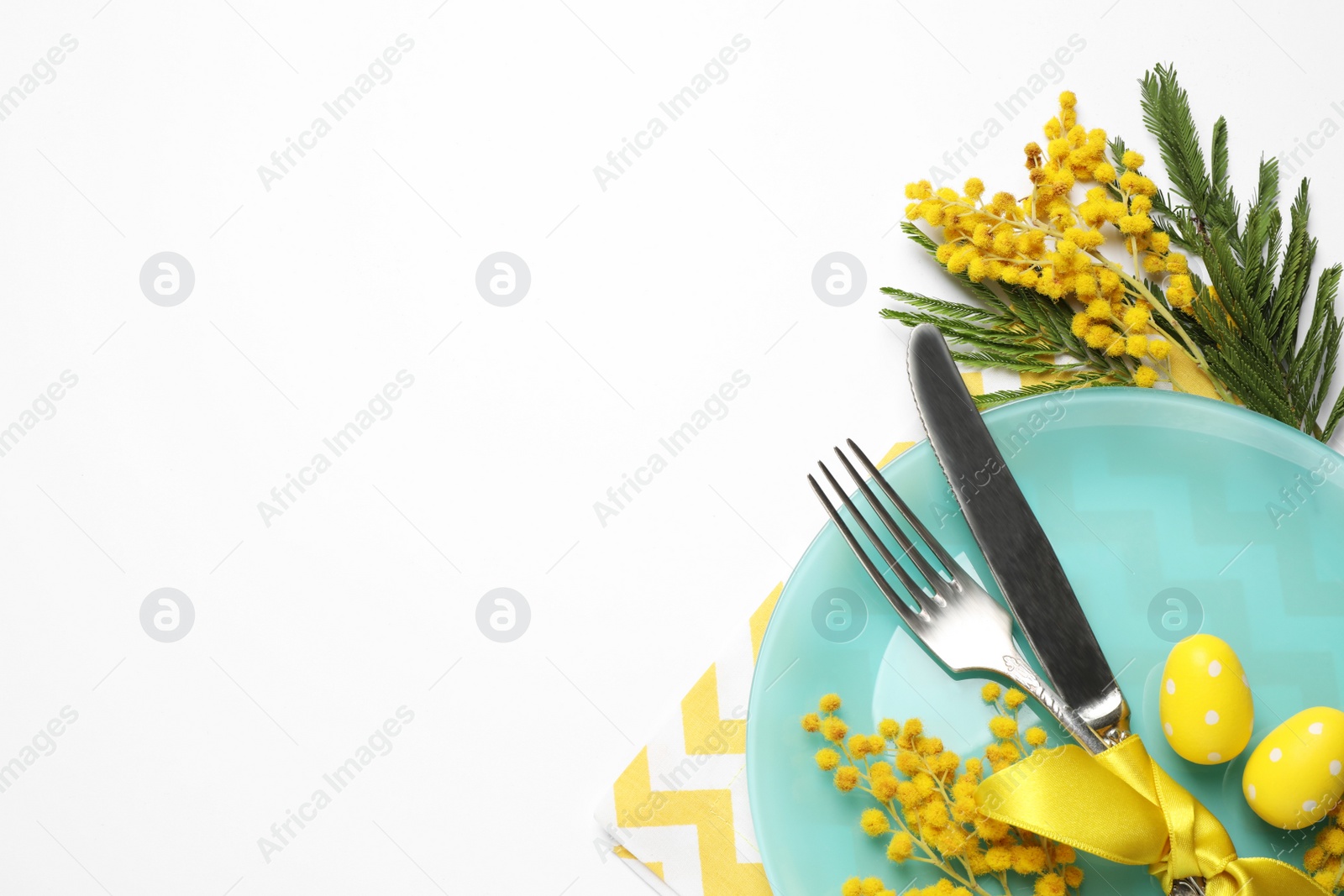 Photo of Festive Easter table setting with floral decor on white background, top view