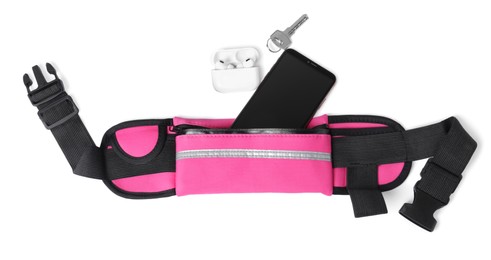 Photo of Stylish pink waist bag with smartphone, key and earphones on white background, top view