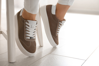 Woman wearing comfortable stylish shoes indoors, closeup