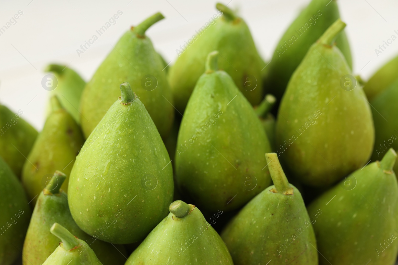 Photo of Many fresh green figs on blurred background, closeup