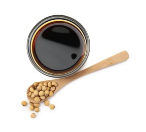Photo of Tasty soy sauce in bowl, soybeans and spoon isolated on white, top view