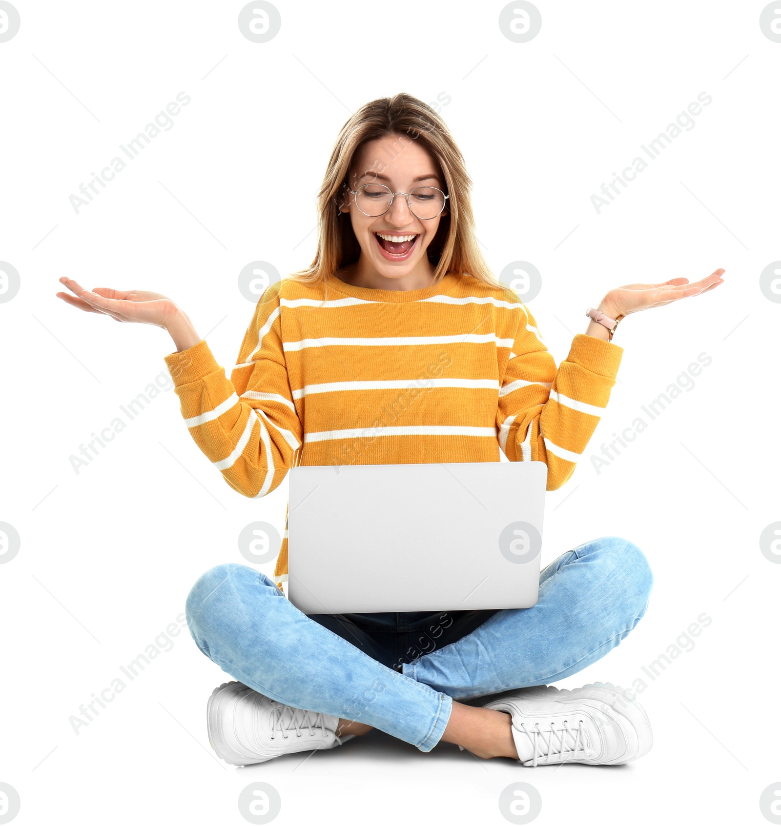 Photo of Young woman in casual outfit with laptop sitting on white background