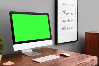 Image of Computer display with chroma key on desk in room. Comfortable workplace