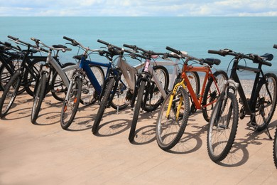 Parking with bicycles on embankment near sea