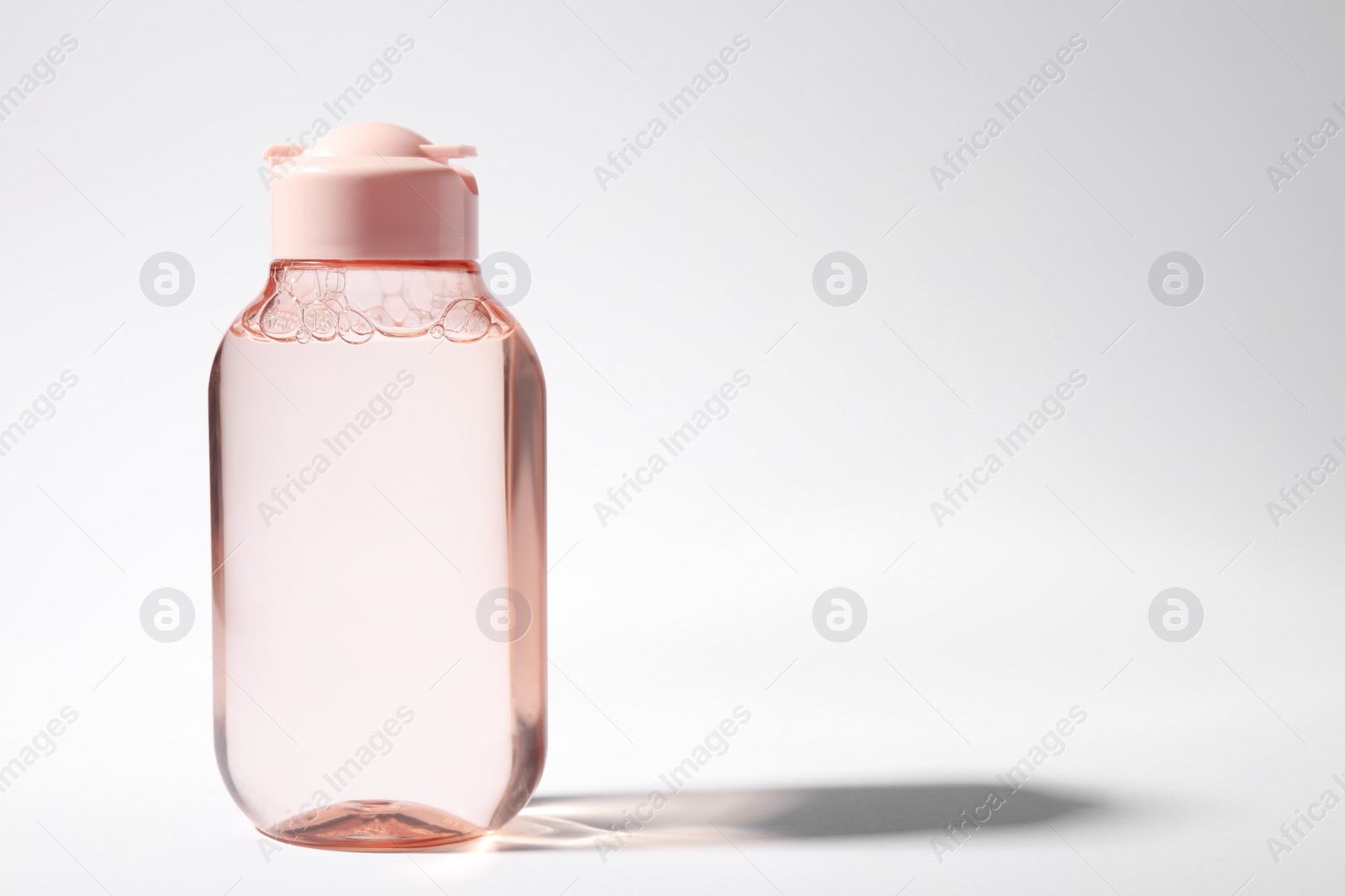 Photo of Bottle of micellar water on white background. Space for text