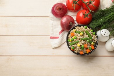 Photo of Delicious pearl barley with vegetables and other products on wooden table, top view. Space for text