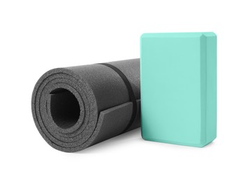 Photo of Grey exercise mat and yoga block isolated on white
