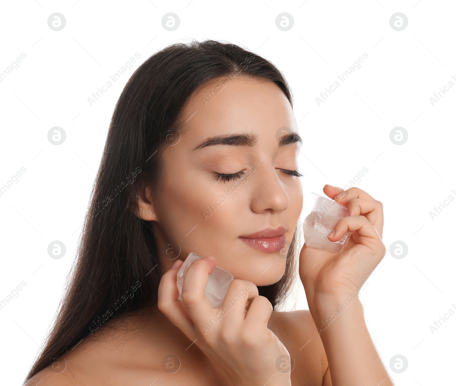 Photo of Young woman with ice cubes on white background. Skin care