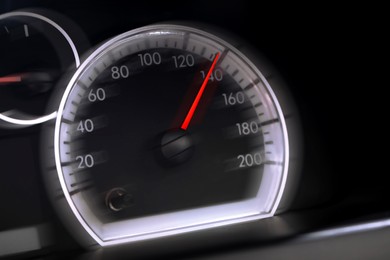 Image of Speedometer on car dashboard, closeup. Motion blur effect