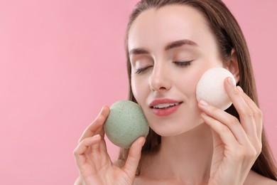 Photo of Happy young woman with face sponges on pink background. Space for text