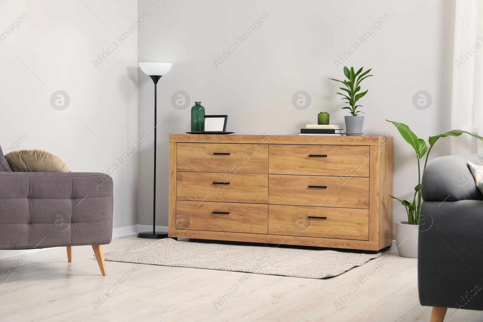 Photo of Cozy room interior with chest of drawers, mirrors and decor elements