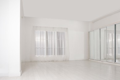 Photo of Empty room with white walls and large window