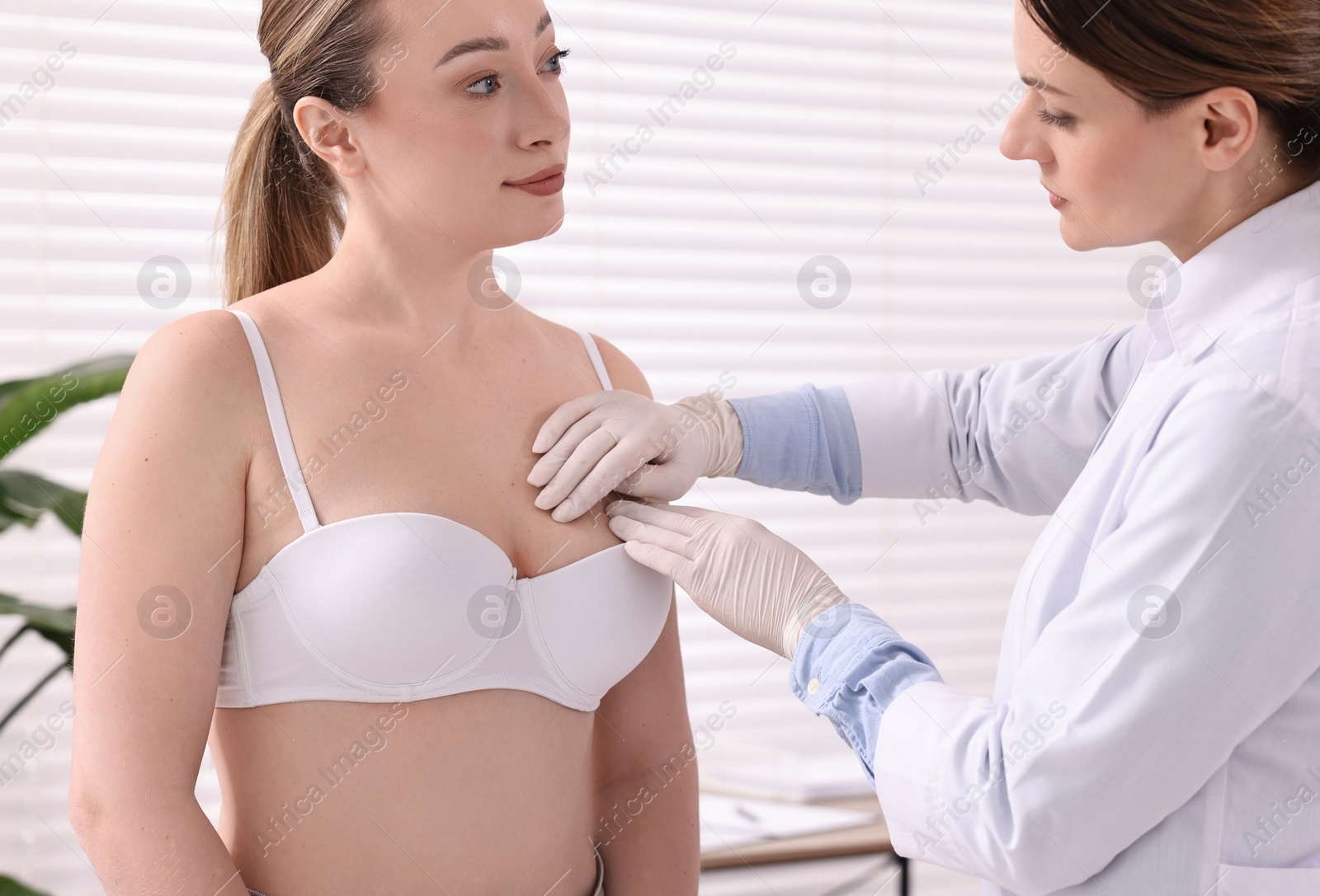 Photo of Mammologist checking young woman's breast in hospital