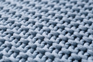 Beautiful light blue knitted fabric as background, closeup