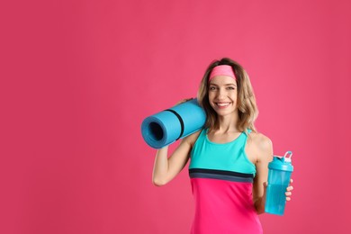 Photo of Beautiful woman with yoga mat and shaker on pink background. Space for text