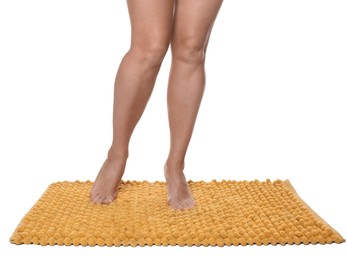 Woman standing on soft orange bath mat against white background, closeup