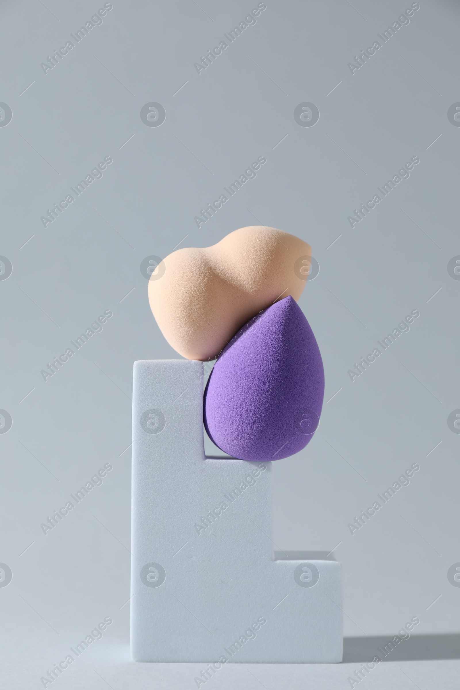 Photo of Stylish presentation of makeup sponges on light grey background