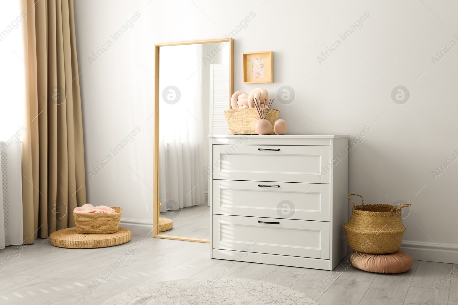 Photo of Modern room interior with white chest of drawers