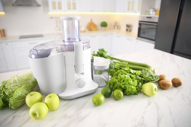 Photo of Modern juicer, fresh vegetables and fruits on table in kitchen