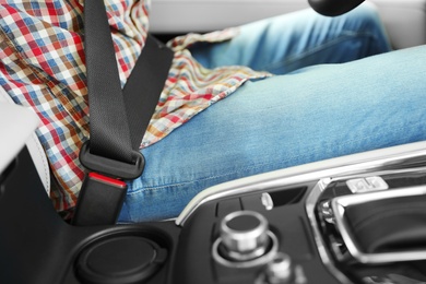 Person with fastened safety belt in car, closeup