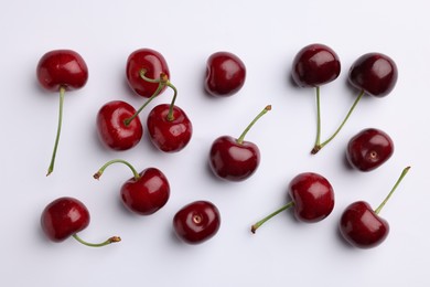 Photo of Many sweet ripe cherries on white background, flat lay