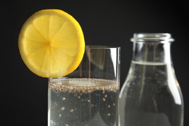 Photo of Composition with water and chia seeds on black background, closeup
