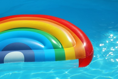 Photo of Inflatable mattress floating in swimming pool on sunny day