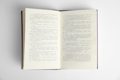 Photo of Open book on white background, top view. Space for text