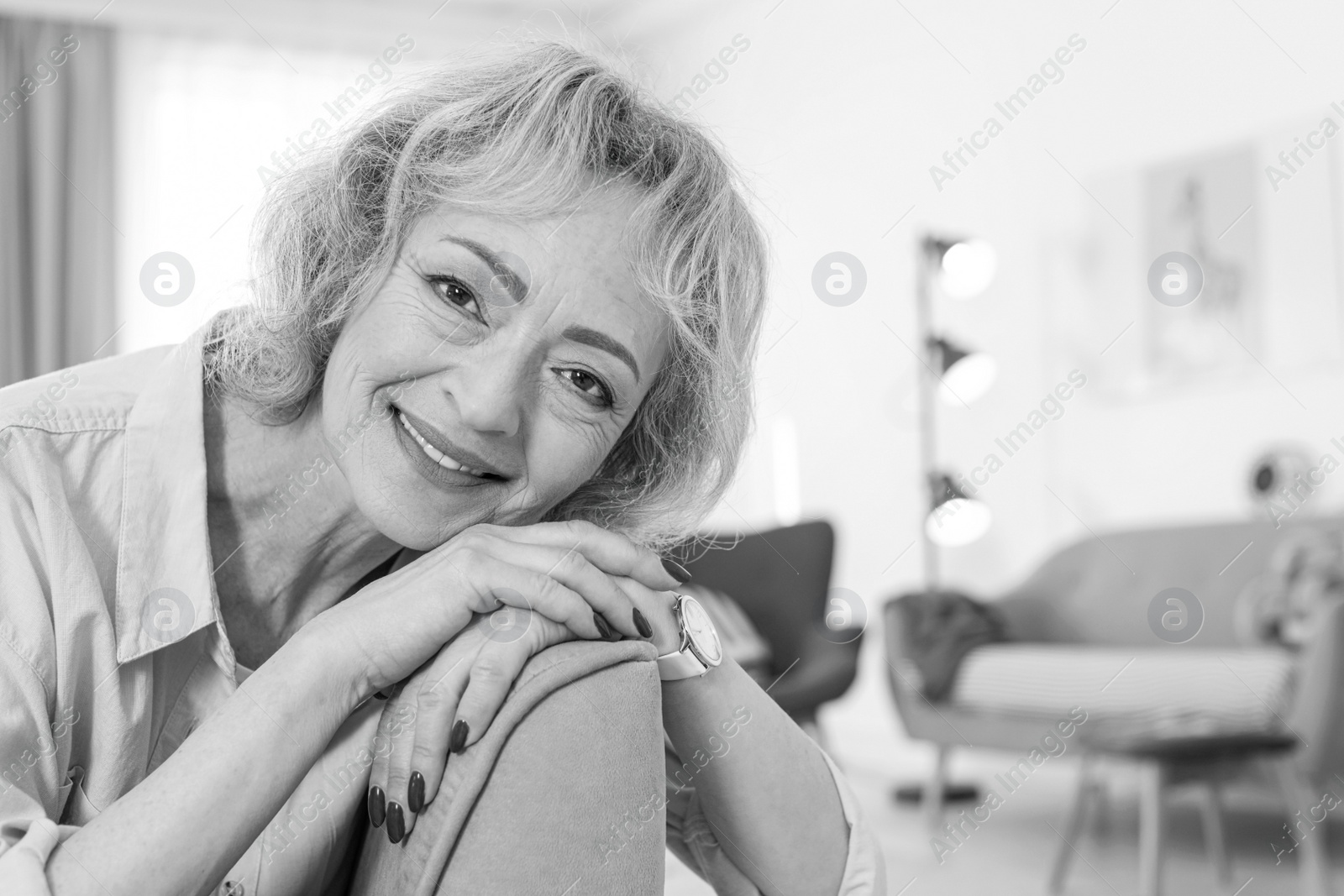 Image of Portrait of mature woman in living room. Black and white photography